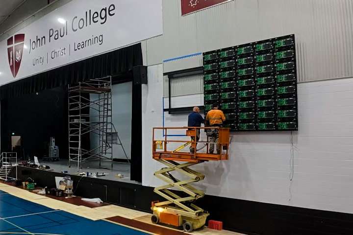 Videopro AV Technicians installing a LED screen into a school multipurpose hall